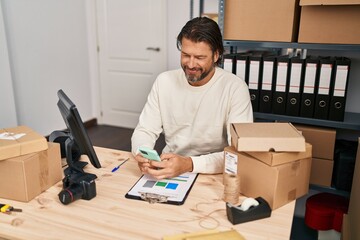 Middle age man ecommerce business worker using smartphone at office