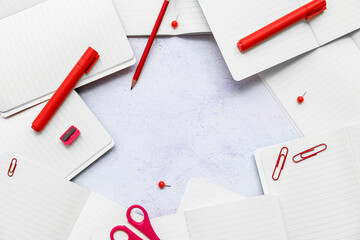 Frame made of blank open notebooks and colorful stationery on light background, closeup