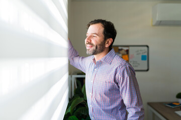 Fototapeta premium Hispanic lawyer smiling at the office while working