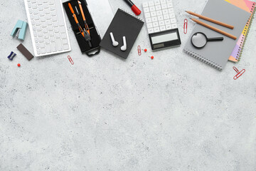 Composition with different stationery and earphones on light background
