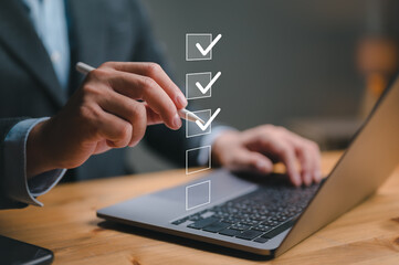 Business performance checklist, businessman using laptop doing online checklist survey, filling out...