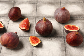 Fresh ripe figs on grey tile background