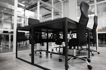 Comfortable office chairs and tables in meeting room, low angle view