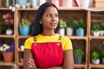 Young beautiful woman florist smiling confident standing with arms crossed gesture at florist