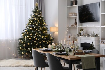 Christmas table setting with festive decor and dishware in living room