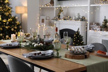 Christmas table setting with festive decor and dishware in living room