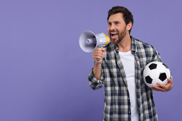 Emotional sports fan with soccer ball and megaphone on purple background, space for text - obrazy, fototapety, plakaty
