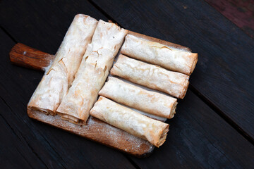 Fresh Baked Apple Pie - Strudel on Traditional Wooden Plate on a Dark Wood Table