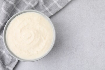 Delicious semolina pudding in bowl on light grey table, top view. Space for text