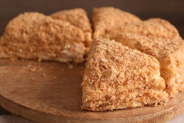 Pieces of delicious Napoleon cake on board, closeup