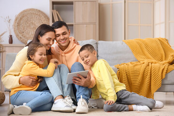 Happy family using tablet computer at home