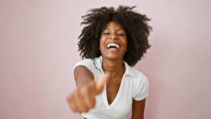 African american woman smiling confident doing ok sign with thumb up over isolated pink background