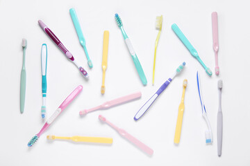 Colorful plastic toothbrushes on white background.