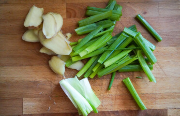 ginger and green onions on cutting board