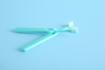 Plastic tooth brushes on blue background.