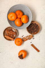 Bowl with pomander balls and cinnamon on white background