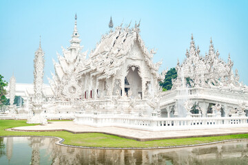 Wat Rong Khun,the White Temple at dawn,and surrounding pond,outskirts of Chiang Rai,Northern Thailand.