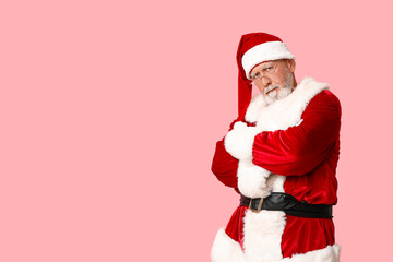 Santa Claus in glasses on pink background