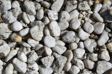Close up textured abstract background of white stone pebbles