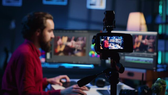Professional camera equipment used by videographer in creative studio. Focus on video production gear in multimedia agency office used by post production editing expert in blurry background