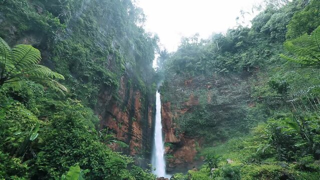 waterfalls from the mountains that flow over rocky hills, east java indonesia