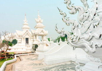 Amongst surreal structures,in the grounds of Wat Rong Khun,fantastical White Temple,Chiang Rai...