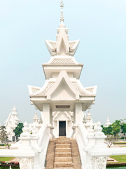 Amongst surreal structures,in the grounds of Wat Rong Khun,fantastical White Temple,Chiang Rai Province,Northern Thailand.