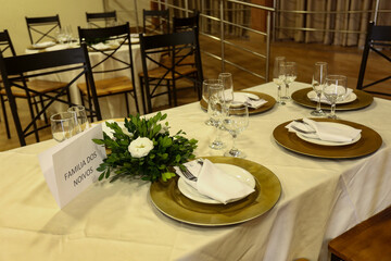 table setting for a dinner, table setting at restaurant, table set for a wedding reception, bride and groom family, reserved table