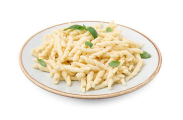 Plate of delicious trofie pasta with basil leaves isolated on white