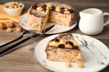 Piece of delicious Kyiv Cake served on wooden table, selective focus. Space for text