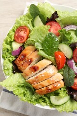 Delicious salad with chicken and vegetables on table, top view