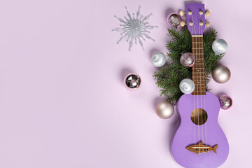 Obraz premium Composition with ukulele, fir branches and Christmas decorations on lilac background