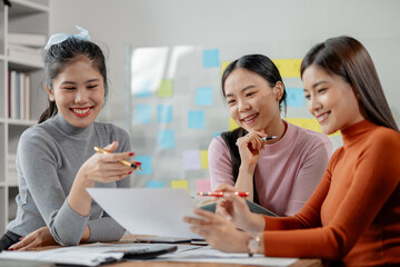 Attractive businesswoman heads strategy meeting in board room, Happy different aged business team having fun on office meeting, talking, laughing, brainstorming at conference table.