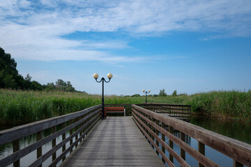 View of the promenade in the village of Yantarny along the Baltic Sea line on a sunny summer day,...