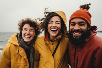 Portrait of a smiling diverse group of friends on winter beach - Powered by Adobe