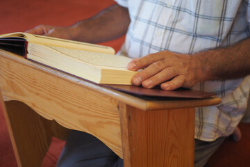 Fototapeta na wymiar muslim man hand holding Holy book Quran at mosque 