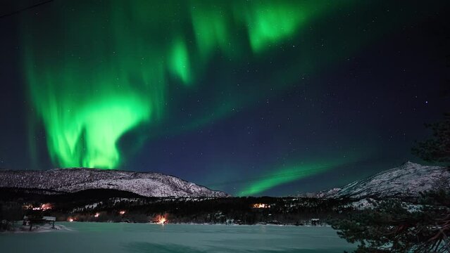 An exceptionally strong aurora dancing above a frozen lake in early December.