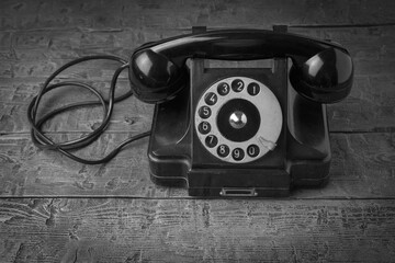 A retro telephone set on a wooden table.
