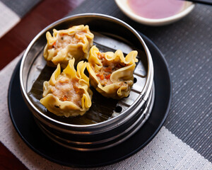 Appetizing steamed dumplings Siu mai (Shumai) with pork. Japanese and Chinese food