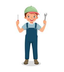 Cute little boy mechanic holding wrench and screwdriver