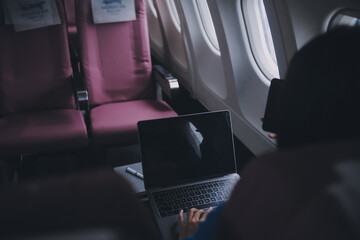 Using mobile and laptop, Thoughtful asian people female person onboard, airplane window, perfectly capture the anticipation and excitement of holiday travel. chinese, japanese people.