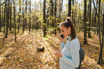 Beautiful girl uses phone for fitness or yoga. Body positive, sports for women, harmony, healthy lifestyle, self-love and wellness.