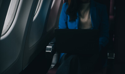 Fototapeta na wymiar Using mobile and laptop, Thoughtful asian people female person onboard, airplane window, perfectly capture the anticipation and excitement of holiday travel. chinese, japanese people.