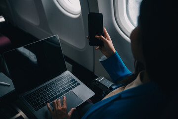 Using mobile and laptop, Thoughtful asian people female person onboard, airplane window, perfectly...