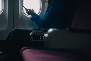 Using mobile and laptop, Thoughtful asian people female person onboard, airplane window, perfectly capture the anticipation and excitement of holiday travel. chinese, japanese people.