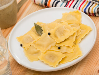Traditional Italian ravioli served on white plate ..