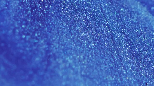 Wet glitter wave. Metallic paint flow. Blur shiny sparkling blue color grain texture ink drip motion art abstract background with copy space.