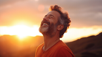 Carefree man smiling with mountain and sunny background.