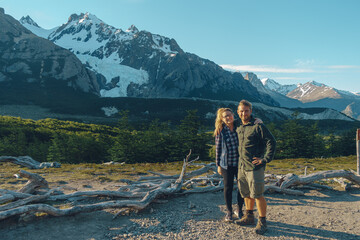 couple posing in a nice iconic view of Patagonians mountains