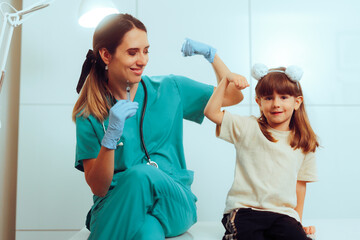 Strong Little Girl Getting her Vaccine from her pediatric Nurse. Happy cheerful child feeling great...